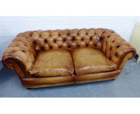 A brown leather Chesterfield two seater sofa,  70 x 195cm