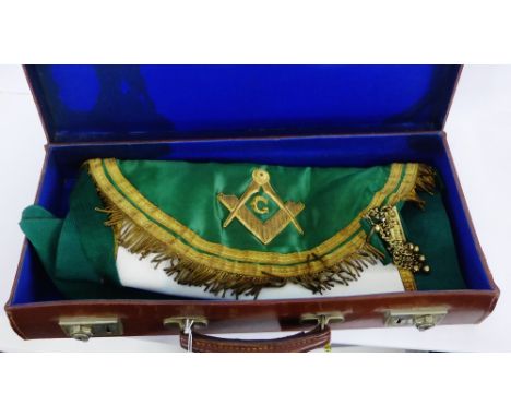 A Masonic apron with gilt metal mounts, together with a Rifle Lodge No.405 sash, all in a brown leather case 