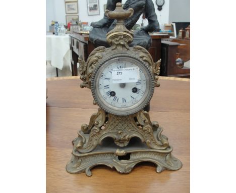 A gilded brass mantel clock