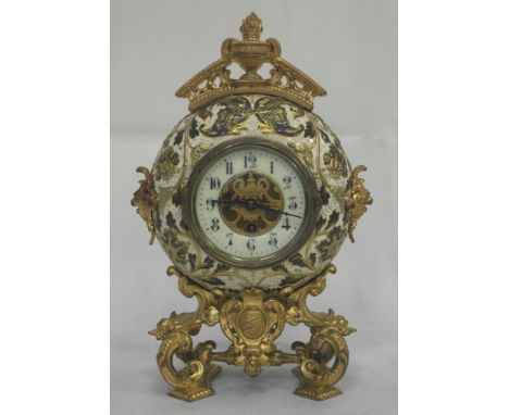 A 19th Century Continental Ceramic and Gilded Spelter Mantel Clock:
a circular ceramic clock, decorated with gilded and green