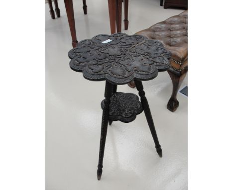 A 19th Century tripod table with leaf decoration