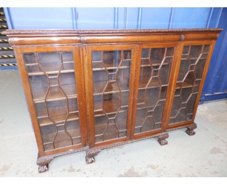 An early 20thC mahogany Chippendale Revival glazed dwarf bookcase on claw & ball feet, Height 49.5”, Width 72”.