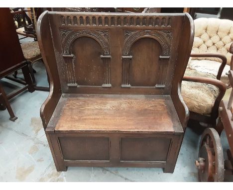 Carved oak hall bench with carved panelled back and rising lid to seat, 86cm wide, 42cm deep, 103cm high