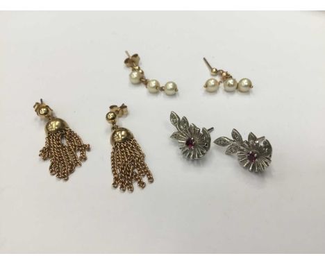 Three pairs of gold earrings to include a pair of 9ct white gold diamond and ruby flower earrings, 9ct gold tassel earrings a