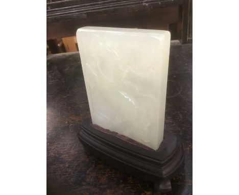 A white jade plaque relief carved with a horse, 11cm high, on hardwood stand