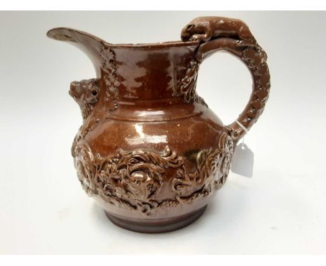 Castle Hedingham Edward Bingham brown glazed pottery jug, with lion on handle and mask decoration, 22cm high