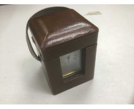 Brass carriage clock by Matthew Norman, approximately 10cm high, in leather case