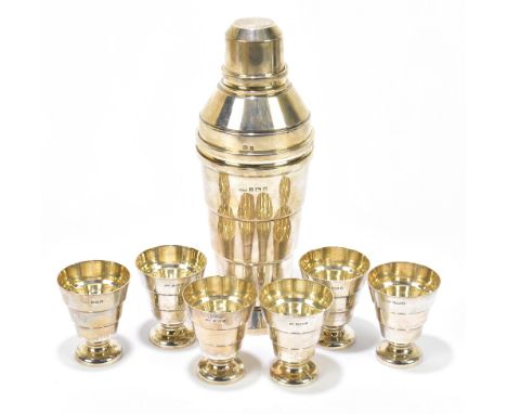 A.L DAVENPORT LTD; a good Art Deco George V hallmarked silver cocktail shaker and six cups of stepped tapering cylindrical fo