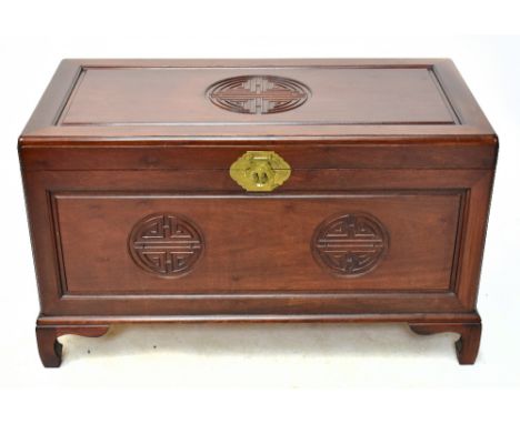 A 20th century Chinese carved rosewood blanket chest, with stylised decoration raised on bracket feet, width 100cm, depth 49c