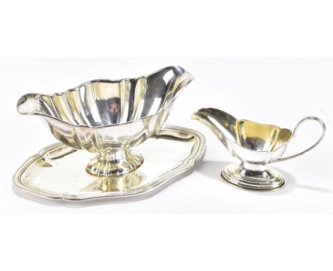A German 800 grade twin lipped sauce boat on integral stand stamped Stutz and a small German 800 grade cream jug, length of s