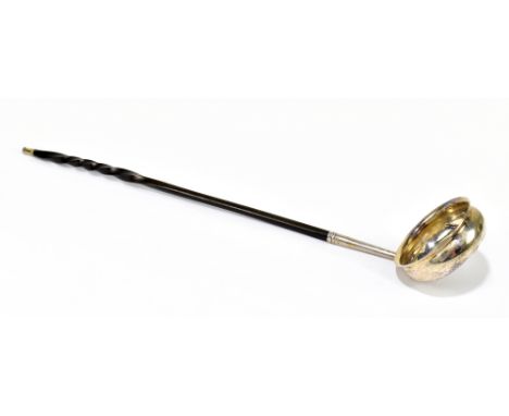 A Georgian white metal toddy ladle set with a George II half guinea, with whale bone handle, length 41cm.