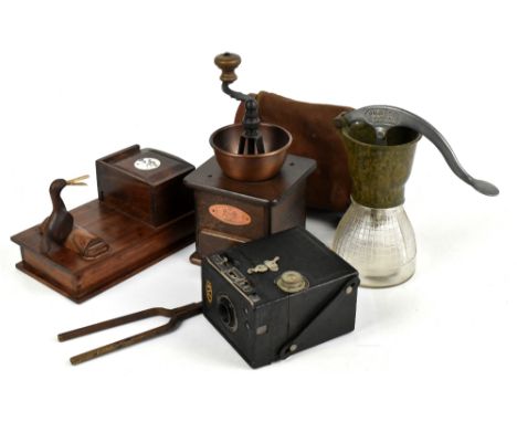 A small group of collectors' items including a coffee grinder, a pair of tongs, cigarette dispenser, camera and cream maker.