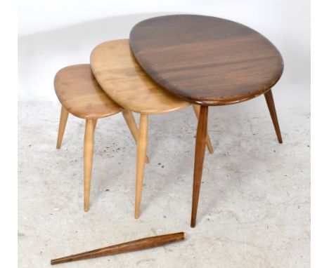 ERCOL; a nest of three graduate pebble tables, originally dark elm but now stripped, width of largest example 60cm (af).Addit