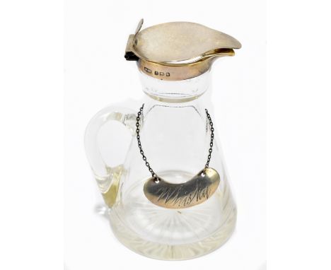 An Edward VII hallmarked silver clear glass whisky jug, with hallmarked silver rim and label, Birmingham 1907/08, height 10cm