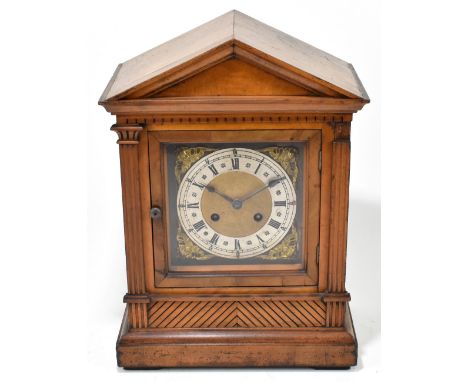 A late 19th century walnut mantel clock, the brass face set with silvered chapter dial with both Arabic and Roman numerals, h