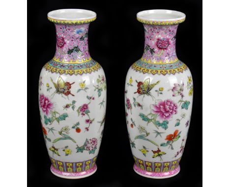 A pair of 20th century Chinese Famille Rose vases, painted with flowers and insects, seal mark to the underside of the base, 