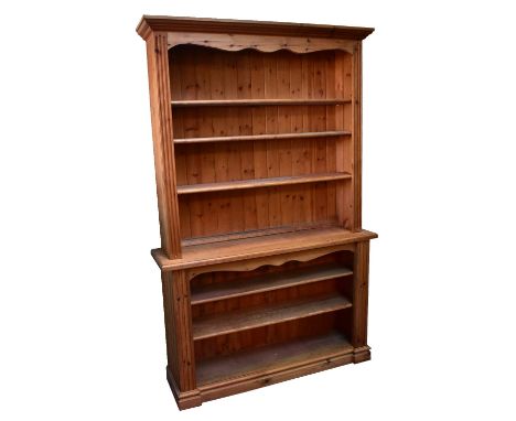 A large modern pine bookcase with single adjustable shelf above the base section with two shelves, height 218cm, width 138cm,