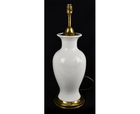 A modern Chinese white glazed ceramic table lamp with gilt metal mount, overall height including fitting 54cm.