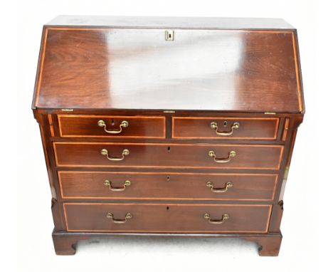 A George III inlaid mahogany bureau, the fall front enclosing central door, fitted compartments and drawers above an arrangem