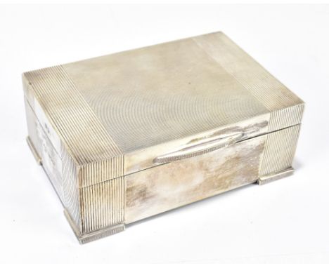 RICHARD WOODMAN BURBRIDGE; an Elizabeth II hallmarked silver cigarette box of rectangular form with engine turned decoration 