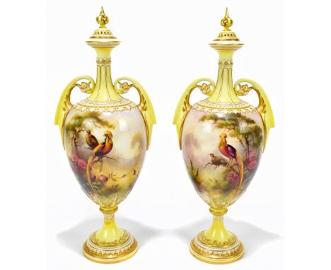 ARTHUR LEWIS FOR ROYAL WORCESTER HADLEY WARE; a large pair of yellow ground gilt heightened pierced twin handled urns and cov