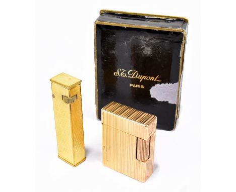 S.T DUPONT; a boxed gold plated table lighter with linear decoration, with certificate, together with a Dunhill lighter with 