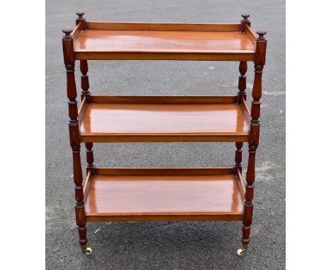 A 19th century mahogany three tier dumbwaiter, raised on column supports terminating on brass/ceramic castors, height 100cm, 