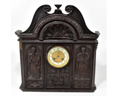 A 19th century carved oak mantel clock, with Macclesfield carved detail inscribed 'My time is in thy hands' above the circula