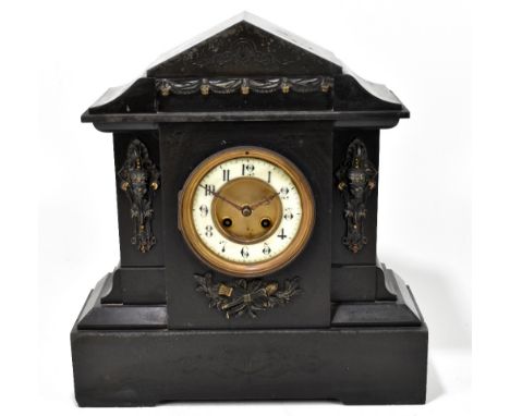 A Victorian slate mantel clock with applied gilt metal detail surrounding a circular dial set with Arabic numerals, height 39