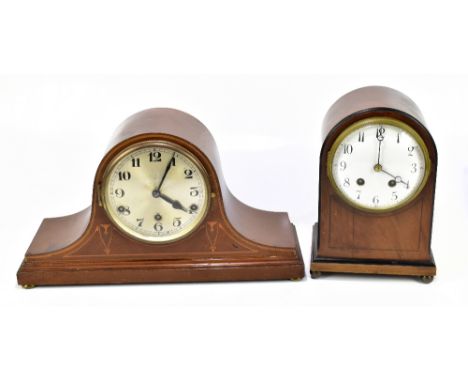 An Edwardian mahogany arch topped mantel clock, the enamelled dial set with both Arabic and Roman numerals, raised on bun fee