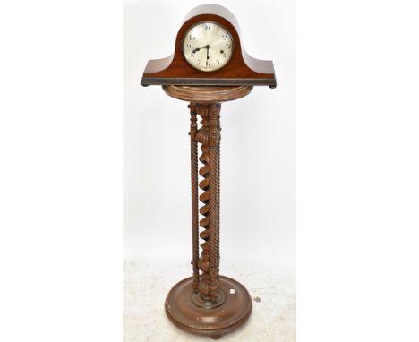 An early 20th century mahogany mantel clock, the silvered dial set with Arabic numerals, with carved detail to the stretcher,