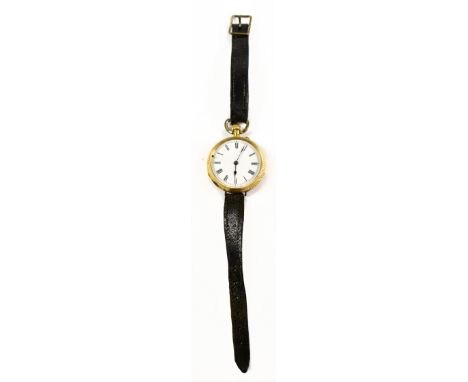 An 18ct yellow gold open face crown wind fob watch with Roman numerals to the white enamel dial and base metal cuvette, now f