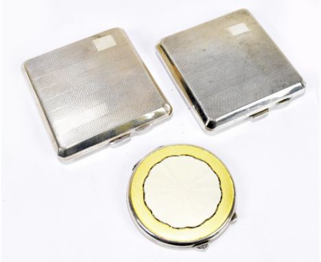A George VI hallmarked silver and pale yellow and cream enamel decorated circular compact, Birmingham 1946, and two hallmarke
