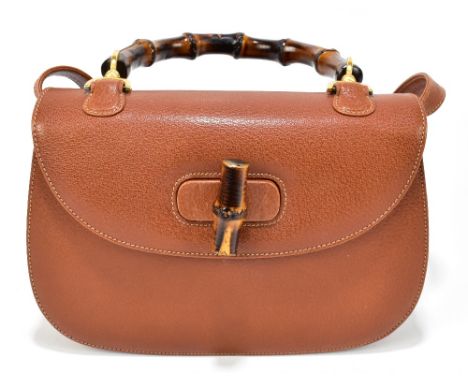 GUCCI; a tan leather two-way handbag with an adjustable removable shoulder strap, a flat fold over top, a bamboo D-shaped han
