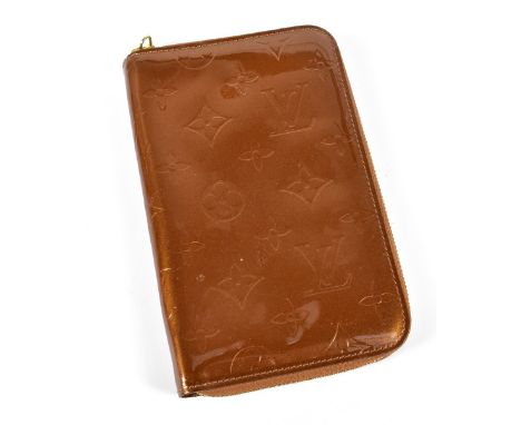 LOUIS VUITTON; a gold brown Vernis enamel patent leather zip around long purse/wallet with gold tone hardware and internal zi