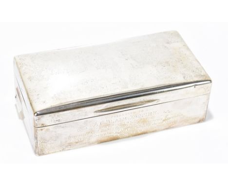 A George VI hallmarked silver cigarette case of rounded rectangular form with presentation inscription beneath the hinged lid