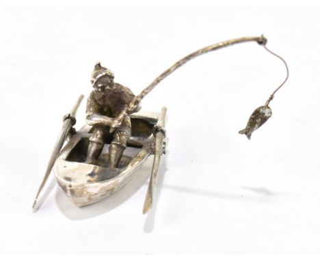 An Elizabeth II hallmarked silver figure of a fisherman seated in a boat, Birmingham 2000.Additional InformationLight tarnish