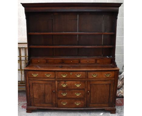 A late 18th/early 19th century Welsh oak dresser with plate rack back, the boarded back section with two thick shelves above 