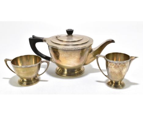 JOSEPH GLOSTER; a George V hallmarked silver three piece tea service, decorated with Celtic strapwork, Birmingham 1936, gross