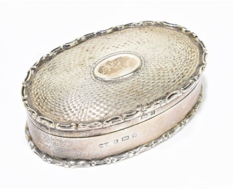 DEAKIN & FRANCIS; a late Victorian hallmarked silver trinket box of oval form, with cast rim and engine turned decoration, Bi