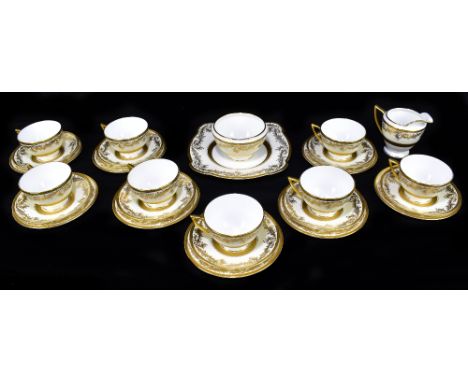 MINTON; a twenty-seven piece part tea service with gilt floral decoration.