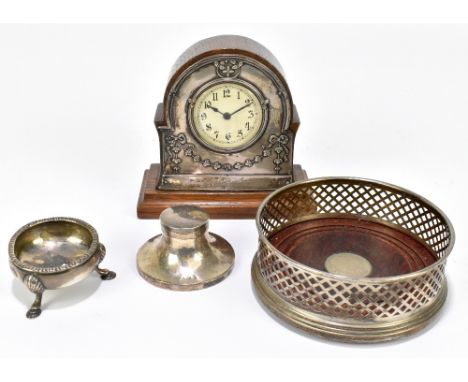An Edward VII hallmarked silver mounted mantel clock, the circular set with Arabic numerals inside a hallmarked silver border