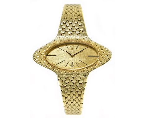 ROLEX; a lady's 1970s 14ct yellow gold wristwatch, the oval dial set with baton markers and with 18 ruby movement no.1401 wit