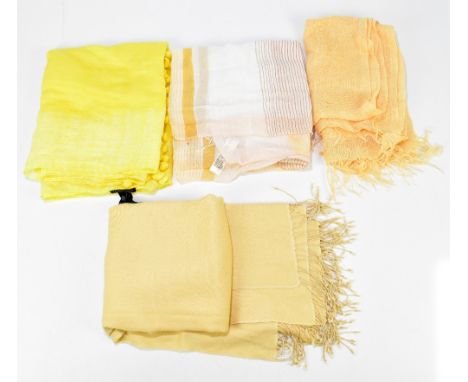 LORO PIANA; a yellow 100% flax long scarf with fringed ends, an Eileen Fisher white, gold and cream 100% cotton scarf, an Eil