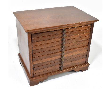 A contemporary mahogany coin collectors' chest of twelve drawers, each with a compartmented interior, on bracket feet, height