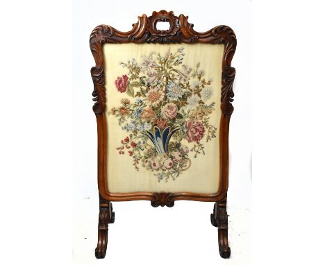 A 19th century carved rosewood framed fire screen, inset with tapestry floral panel, on swept feet, height 126cm, width 74cm.