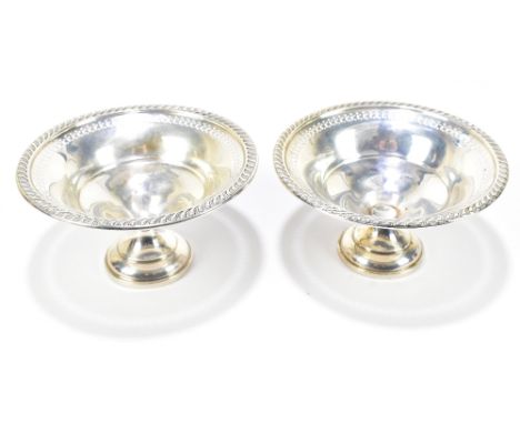 A pair of loaded sterling silver bonbon dishes with pierced circular rims on spreading circular foot, diameter 14cm.Additiona