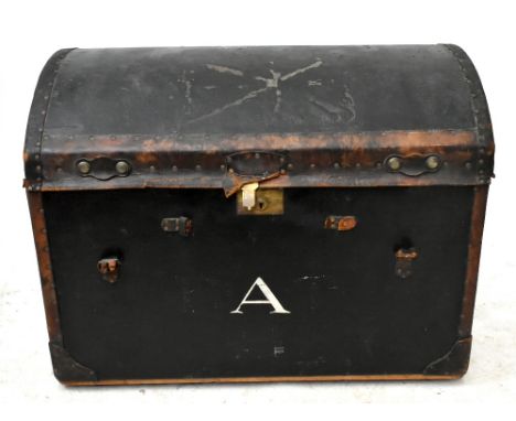 A black dome topped trunk with leather edges, width 84cm.