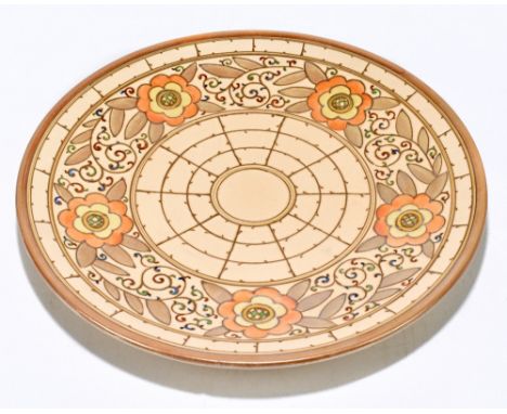 BURSLEY WARE; a ceramic charger with floral and scrolling detail on a beige ground, after a design by Charlotte Rhead, diamet