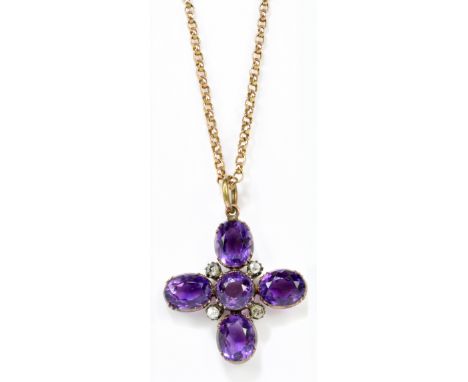 A late Victorian amethyst and diamond cross pendant centred with circular cut amethyst within a frame of four oval cut amethy